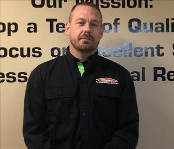 Male SERVPRO Employee Standing in front of wall